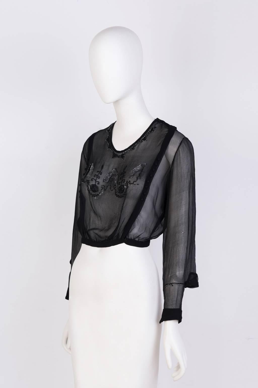 Sheer, black hand-beaded blouse with detailed seaming.