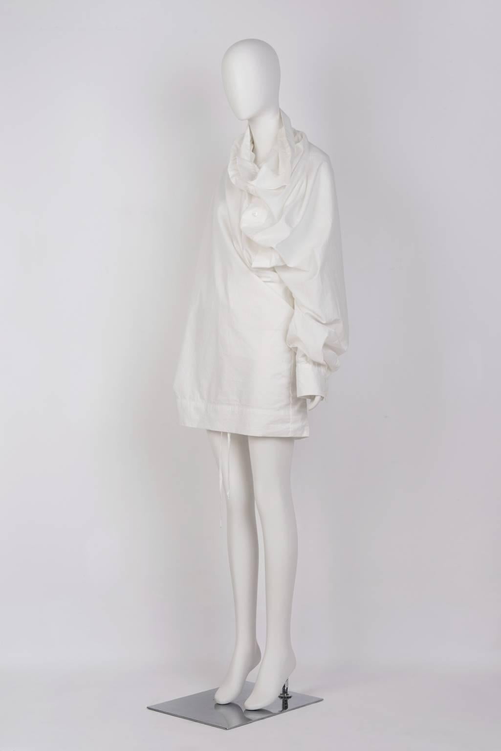 White, off body mini dress/blouse with voluminously twisted tailored sleeve.