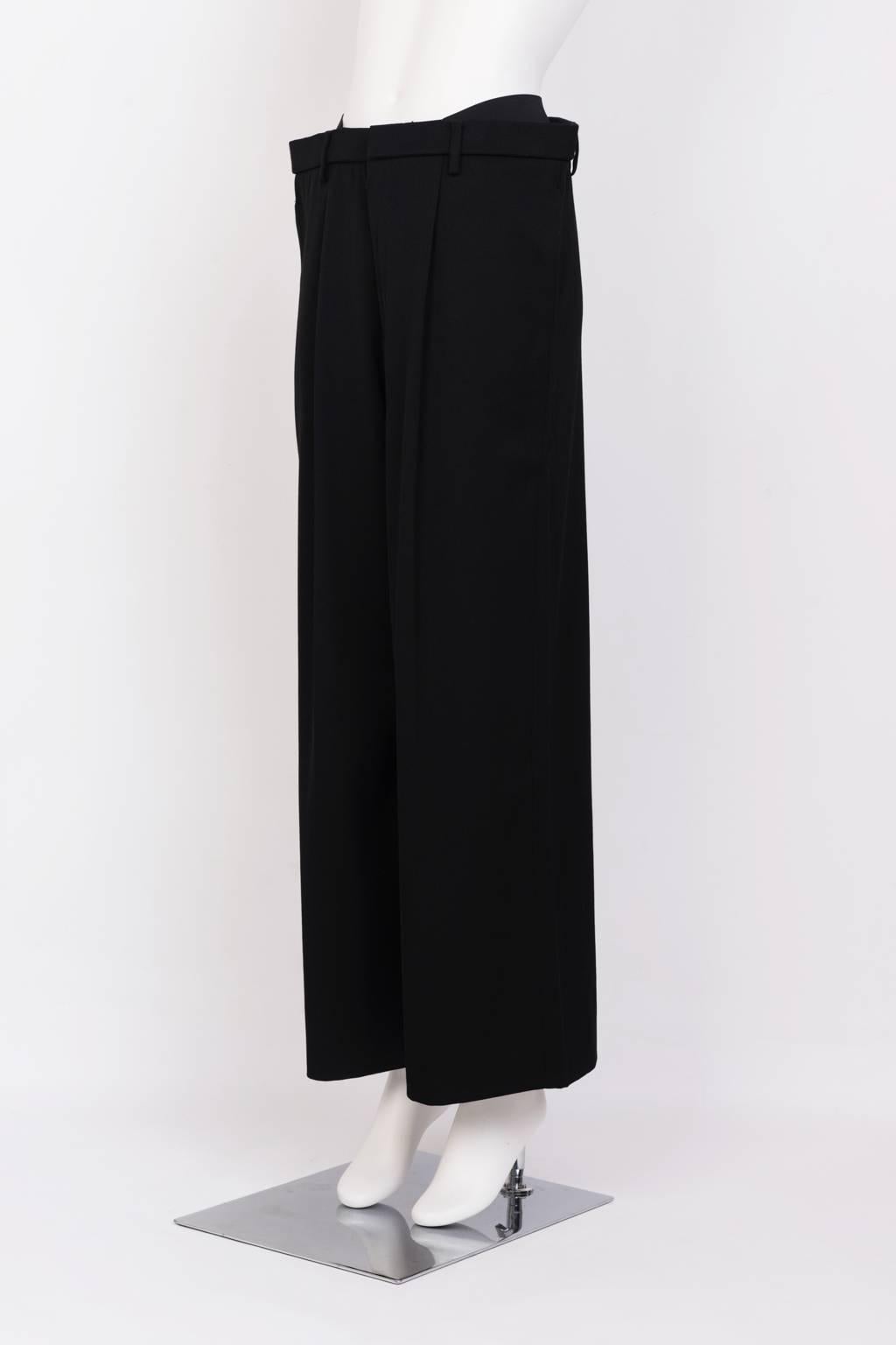 Tailored, single pleat, wide leg wool trouser with slash pockets. From the designer's noted 'Wardrobe' Collection.