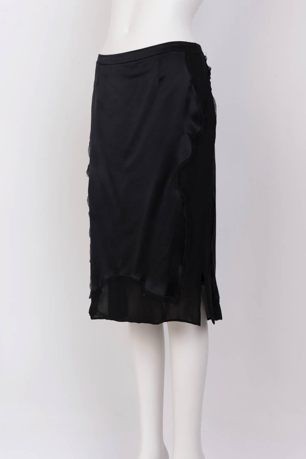 Knee length pencil skirt in black silk crepe with scalloped satin panels, front and back.