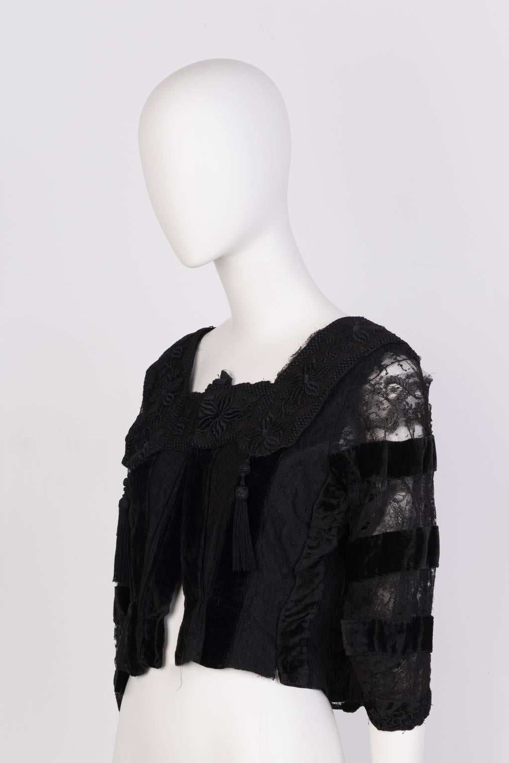 Black lace and velvet Victorian blouse with tassle detail and snap closures.