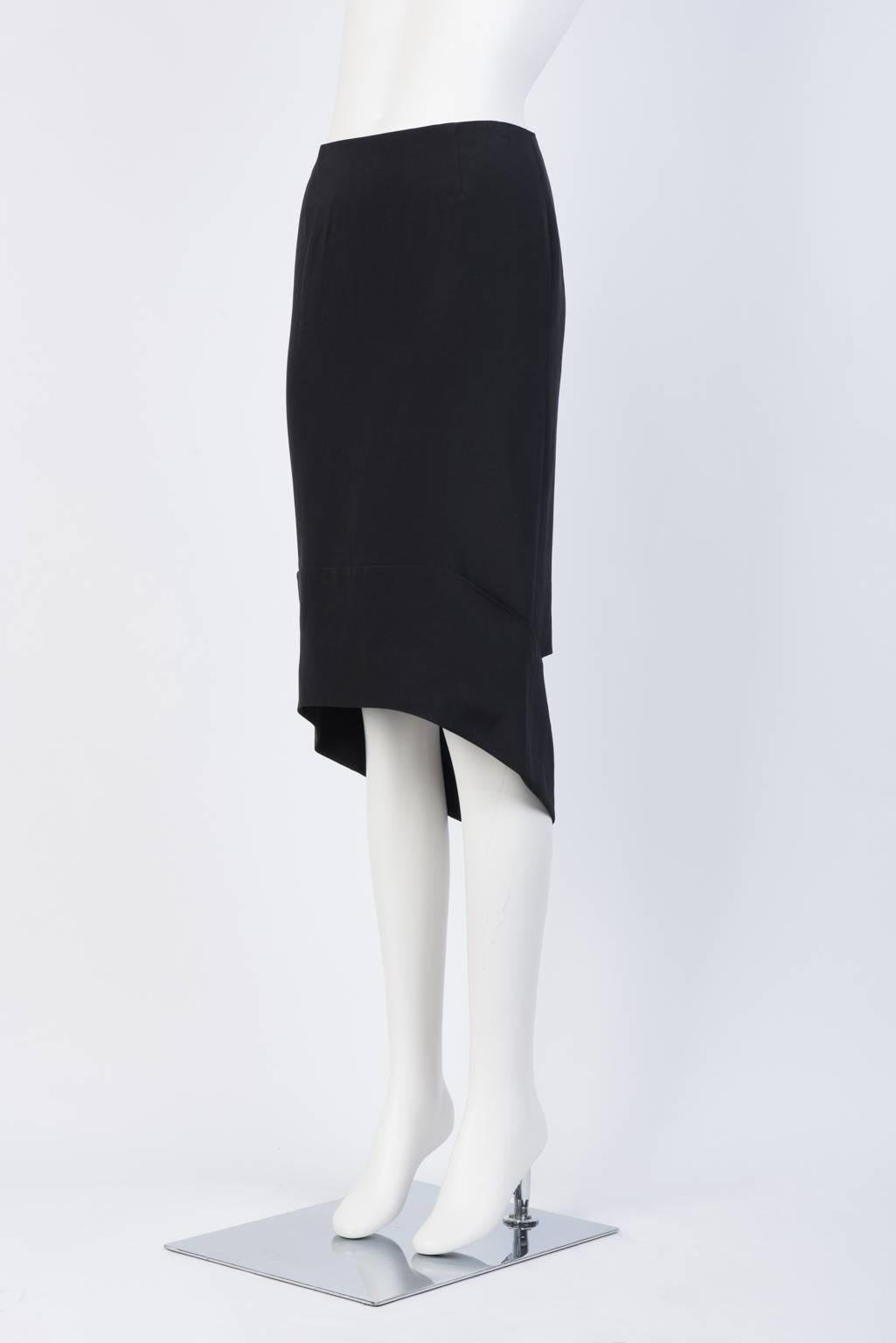 Crêpe de Chine skirt with asymmetrical hem and cut out detaiing in back.