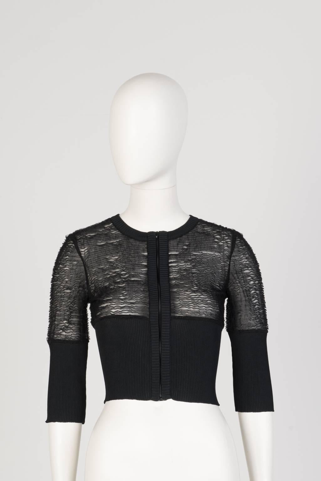 Black, half sleeve, cropped cardigan with sheer bodice and ribbed waist and lower sleeve.