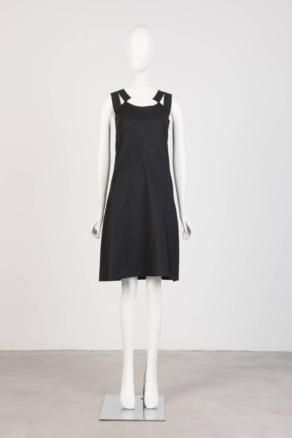 Sleeveless, knee-length cotton/linen dress with side zip and stitch detailing on raw edged straps and back collar.