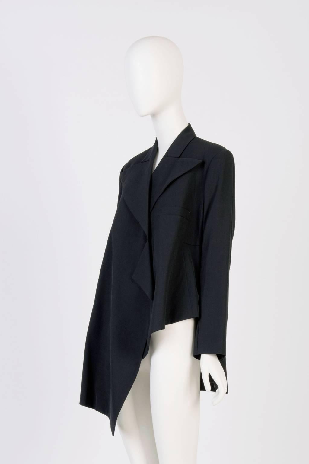 Yohji Yamamoto wool blazer featuring asymmetrical front panels with waterfall like collar. Padded shoulder. Fully lined.