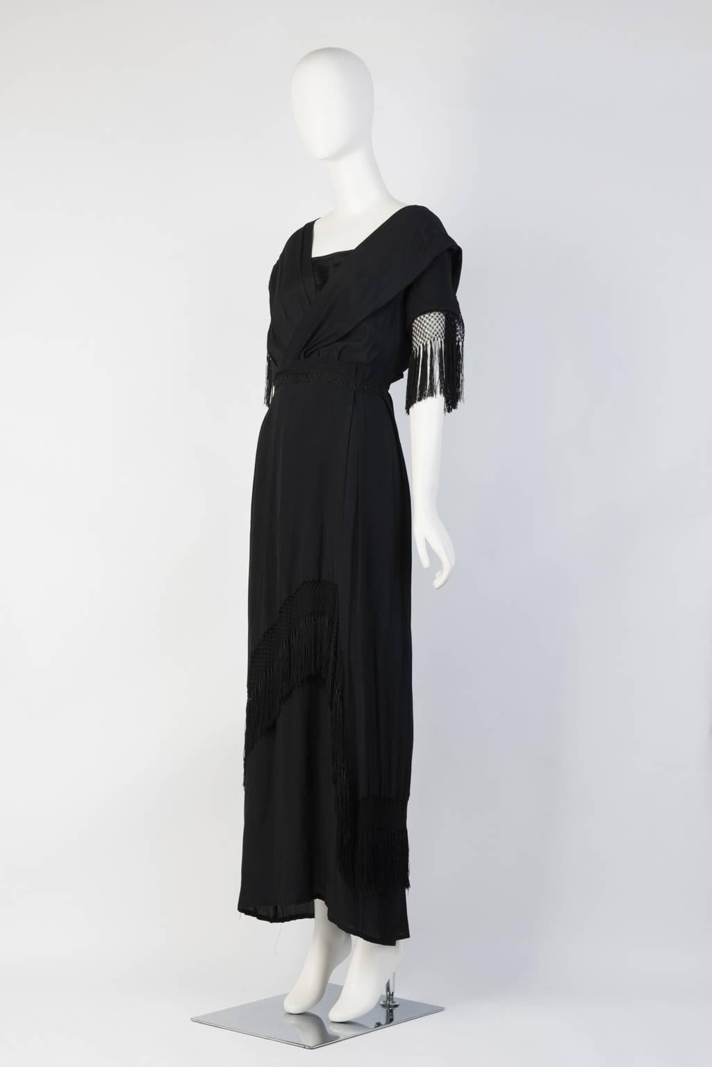 30s tassel dress in crepe chiffon with wrapped exquisite tassel details. Empire waist with lace panel. Normal signs of wear. Few minor torns around the dress.
