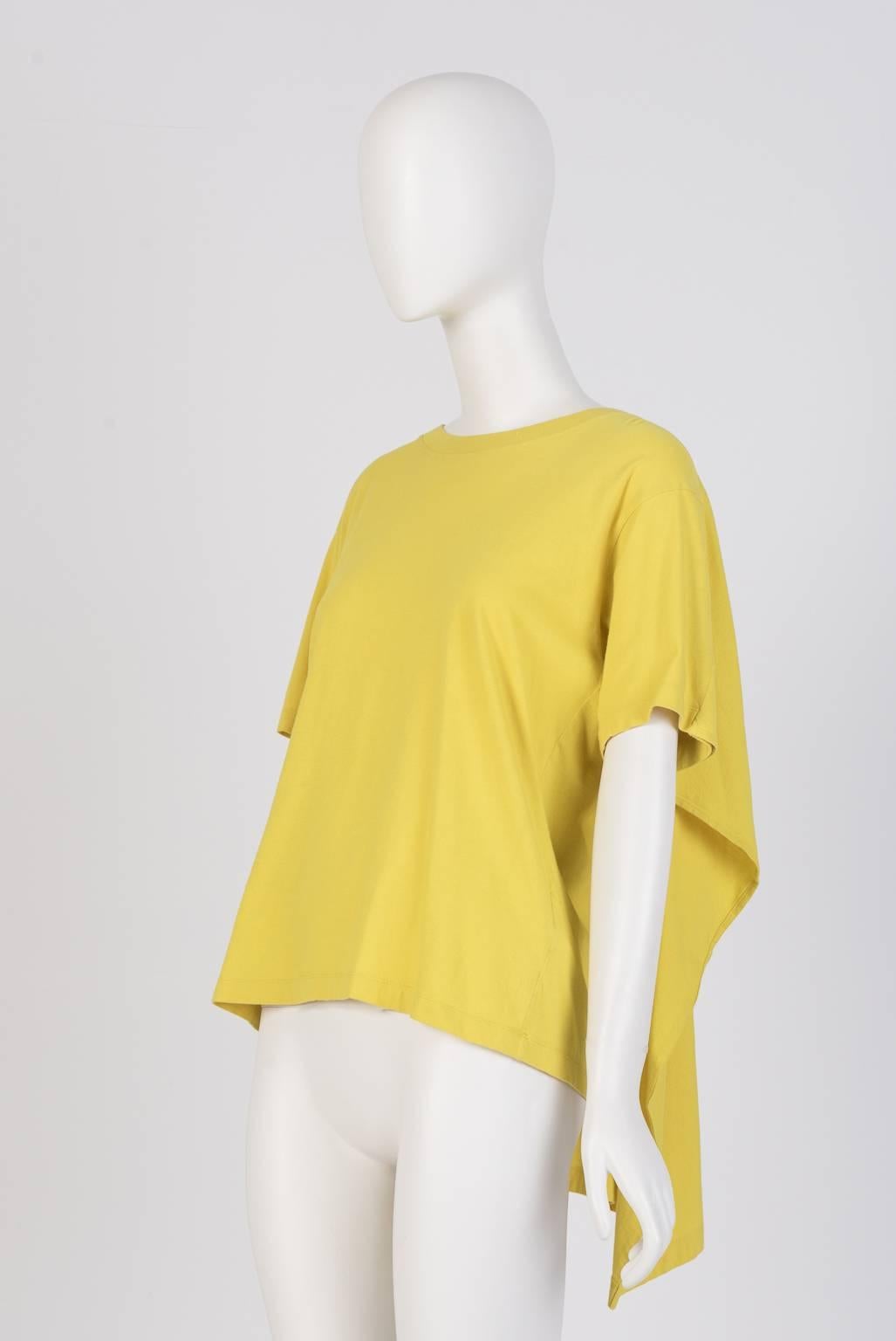 From Margiela era, this Maison Martin Margiela lime yellow T-shirt features an extra layer design, attached to the back panel of the t-shirt which looks like a cape. Could be worn back to front. 