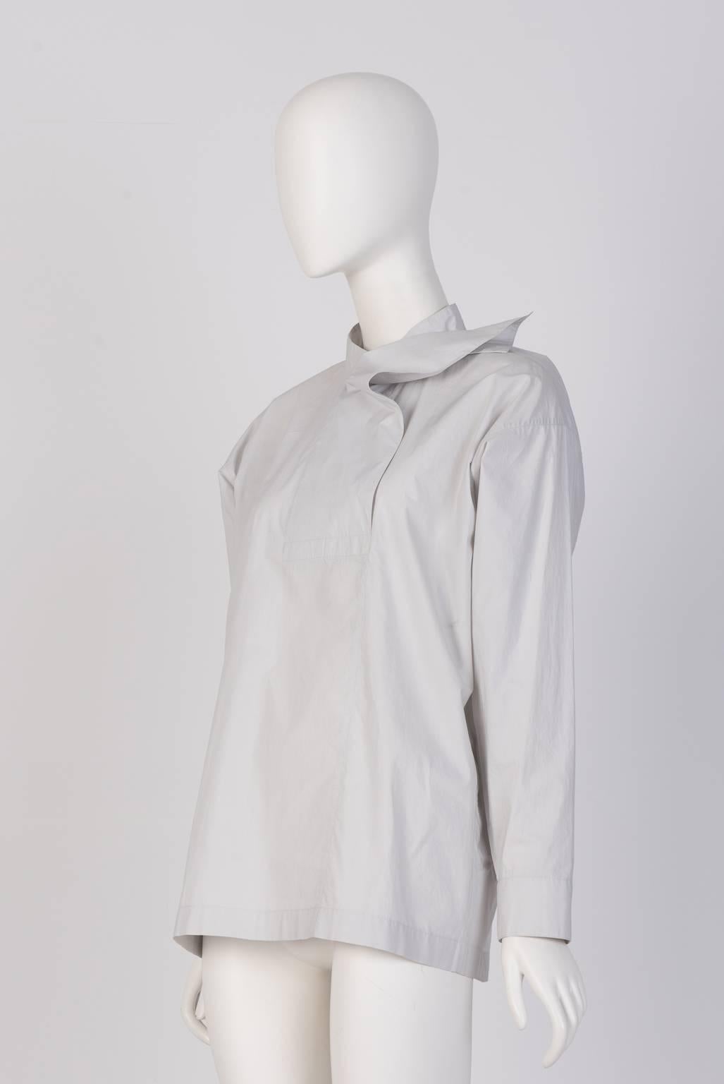 Oversized Issey Miyake poplin cotton shirt with a special unbuttonable collar design. Box pleat at the back. Light Grey color. 