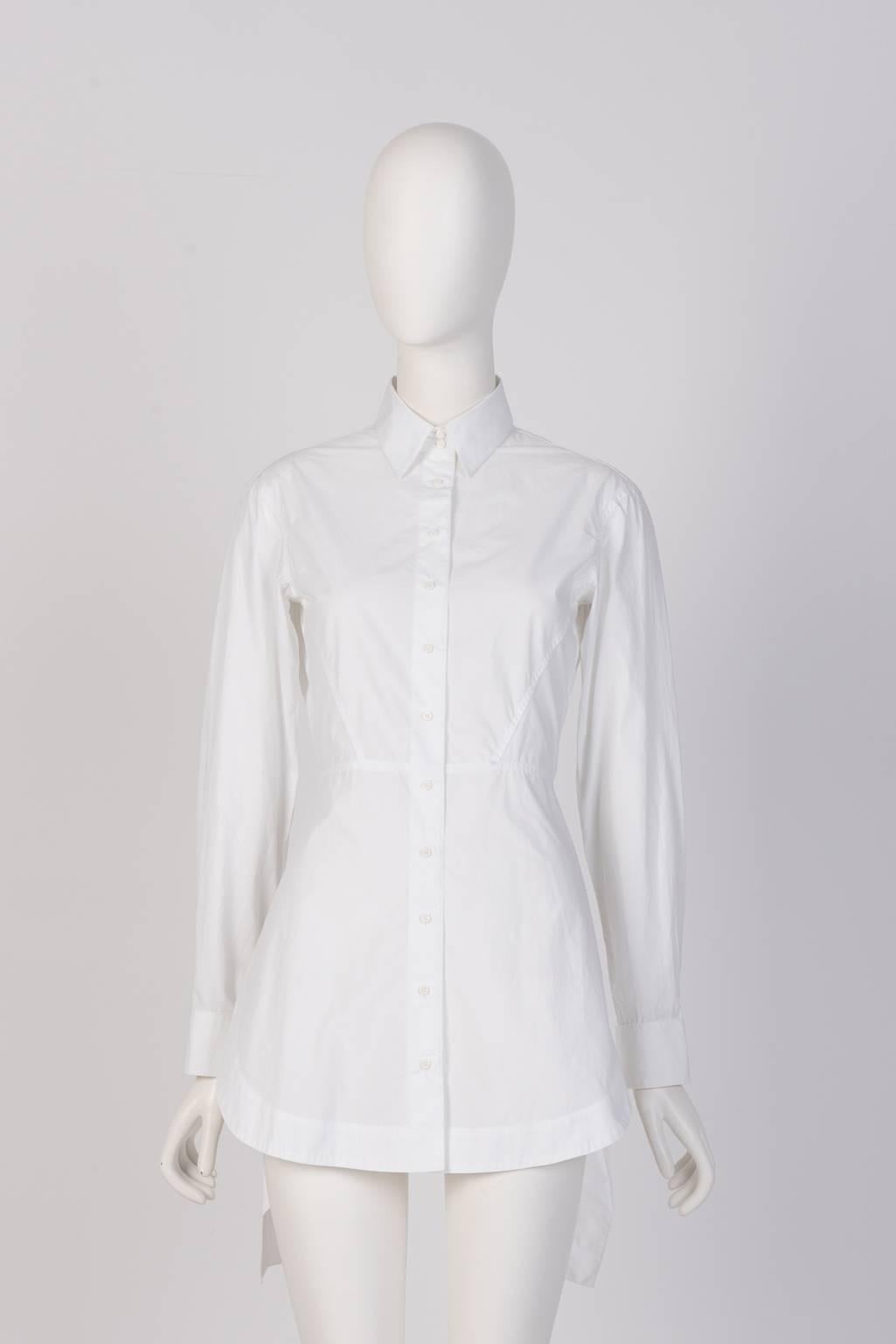 Slim fit Alaïa white cotton shirt featuring a pleated ruffle tail panel at the back.
