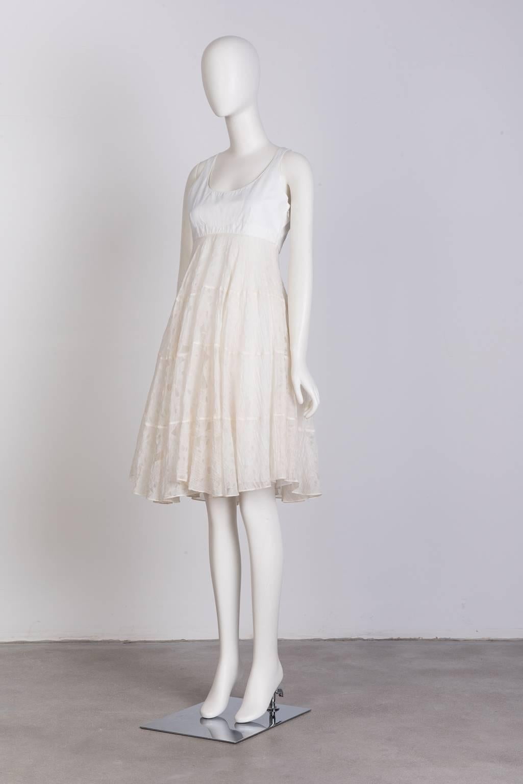 Sleeveless, empire waist dress with crushed silk jaquard skirt and cotton bodice with cut out back detail.