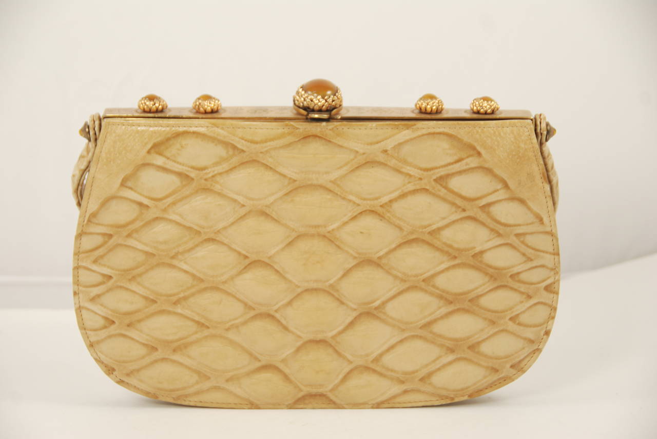 Early Koret handbag, made in France, circa 1940s - 1950s. During this period Koret was a luxury brand and sold in the best stores. Made of snakeskin and leather, the brass frame is etched and has butterscotch colored stones in ornate settings.