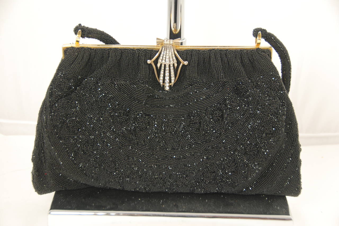 Black beaded evening by Morabito circa 1950s in fantastic condition. Morabito made some of the best beaded bags I have ever seen. The clasp is gilted sterling silver ( there are French hallmarks on the clasp) and rhinestones in a retro design. The