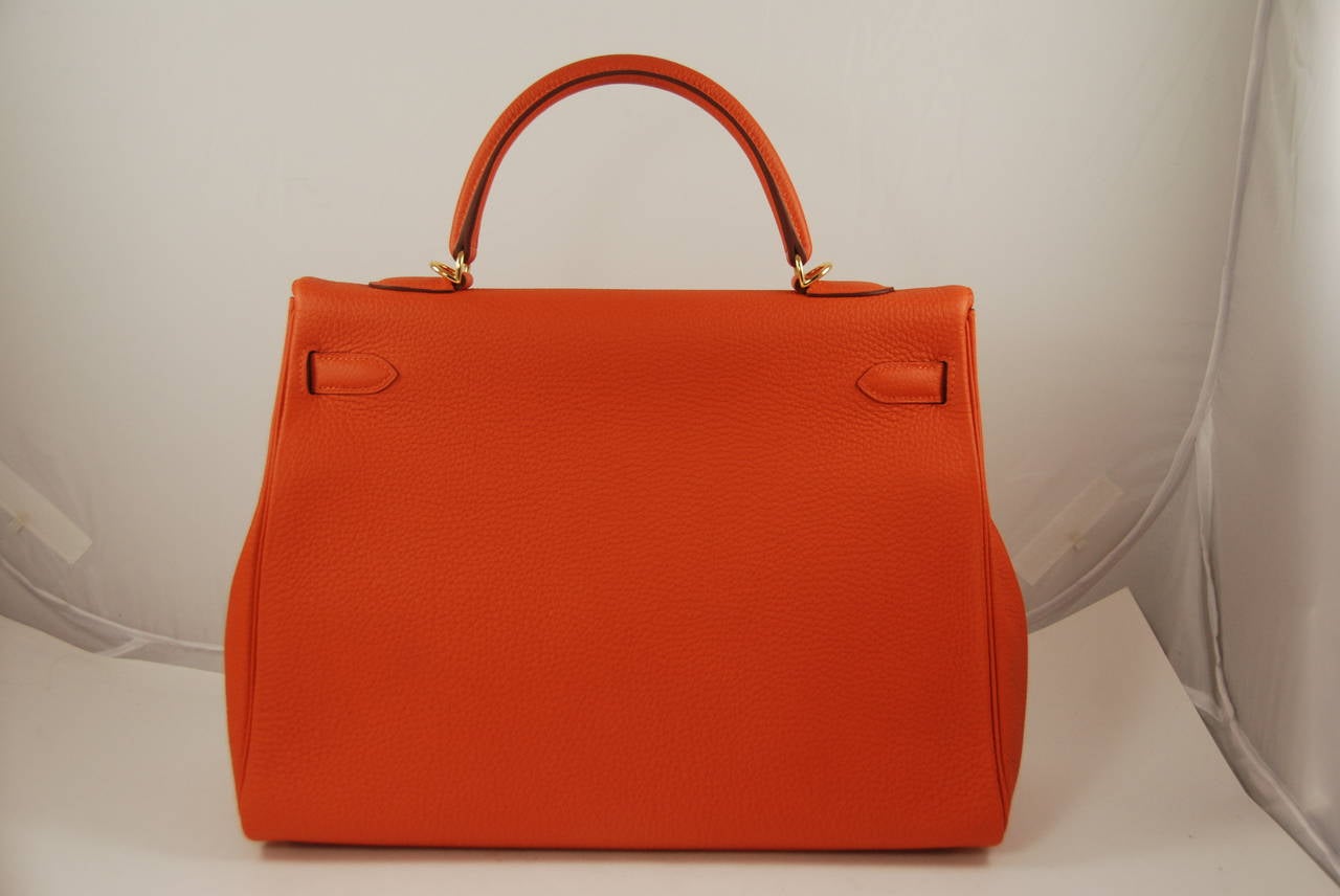 Hermes togo leather 35cm Kelly bag with gold hardware. Purchased at Hermes in 2014, and in pristine condition. Comes with the strap, lock and keys, cloche, raincoat and all the sleeper bags. The feet and some of the hardware still have the original
