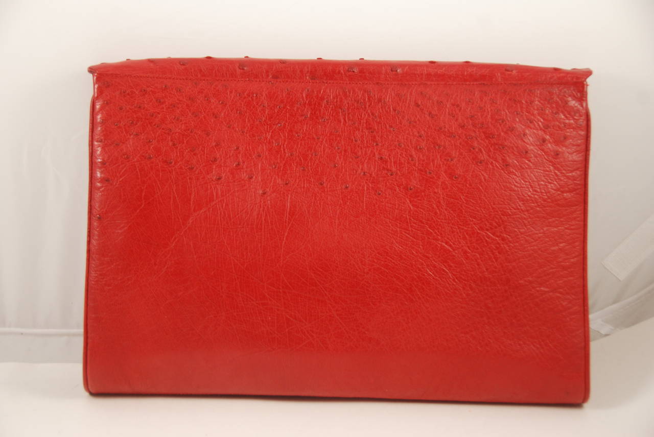 Red ostrich clutch or shoulder bag from the 1980s. The bag was made from one piece of ostrich leather as it includes the smooth skin from the belly. There is a Chanel like chain that is detachable. The chain has a 20