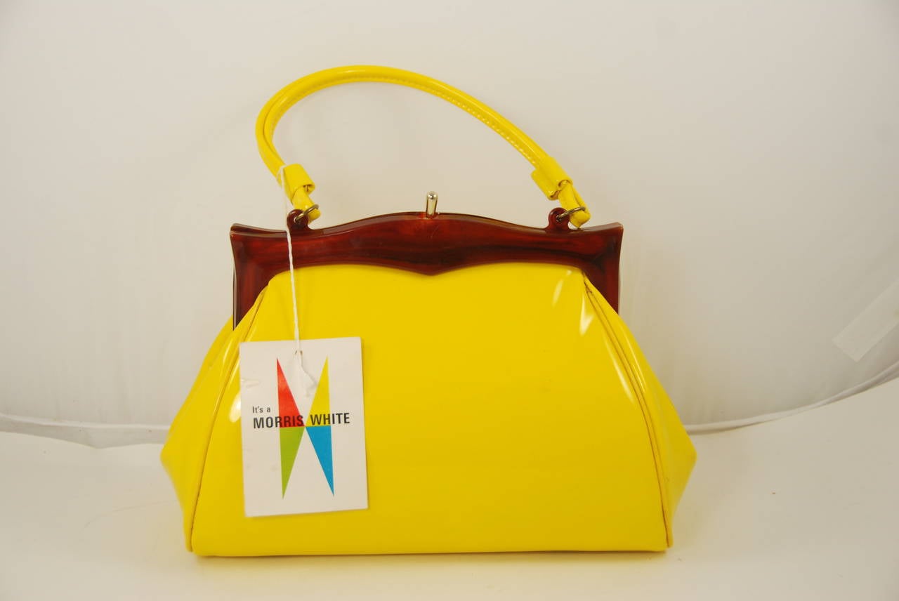 Wow, this bag is fun. THe yellow is such as happy color. From the 1960s and never used. Still has the original tag attached to the bag. I bet Peggy from Mad Men would have carried this bag. The rear of the original tag says 