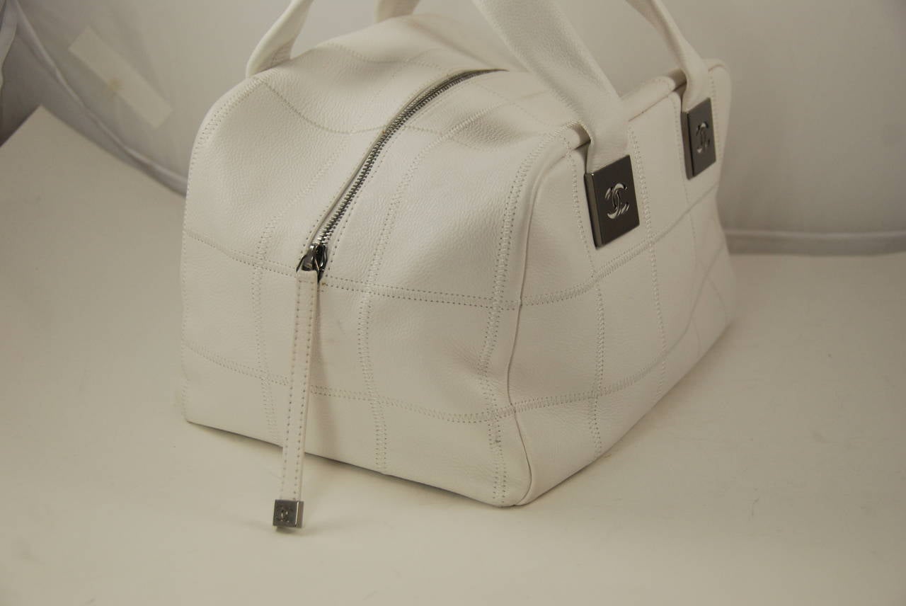 White caviar leather Chanel top handle bowler bag circa 2003. This bag is in excellent and clean condition inside and out. The lining is cream satin with 