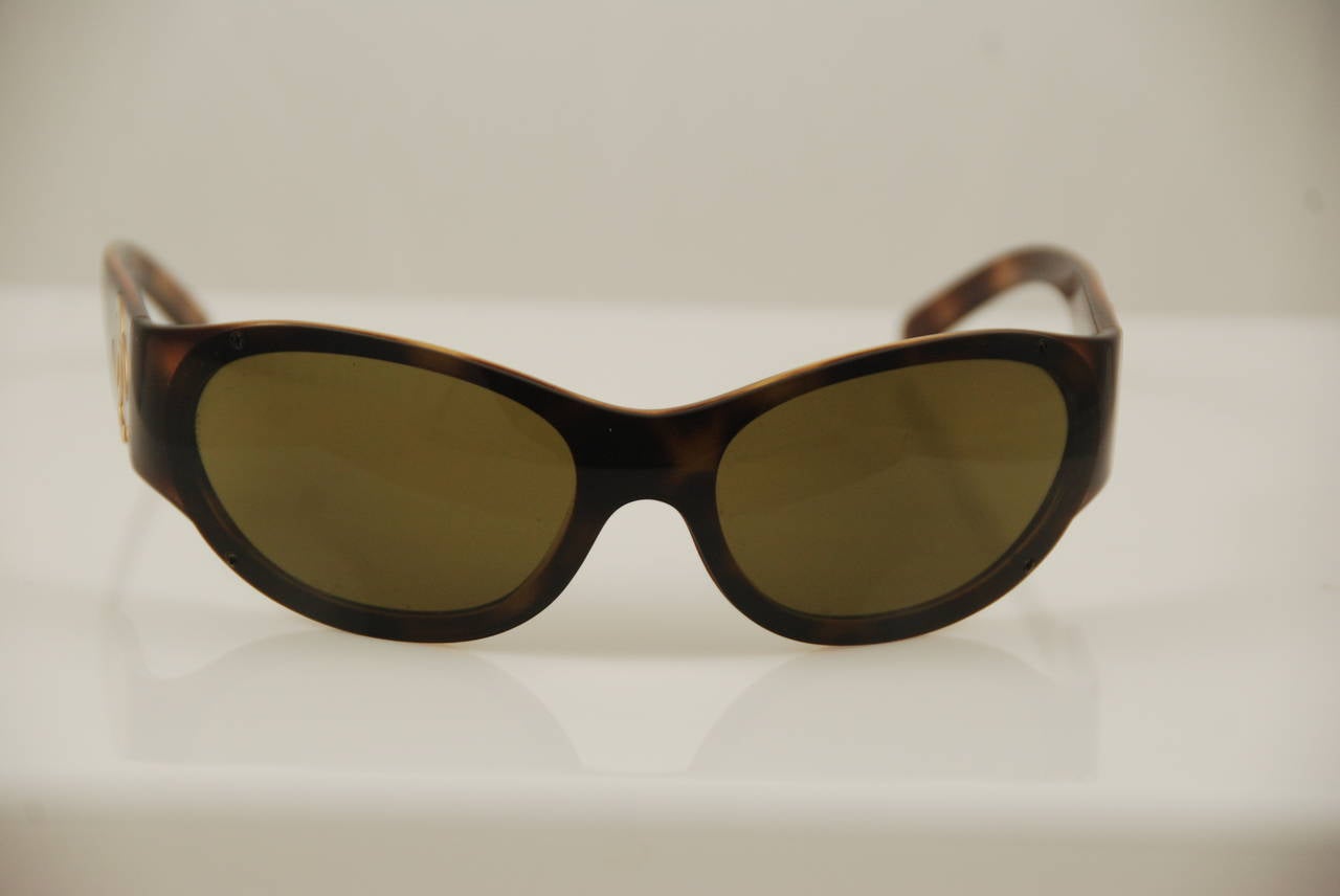 Chanel sunglasses with tortoise shell frame. The lens are curved. Chanel is etched into the frames over the nose bridge.No scratches on the lenses. Comes with CHanel case. There is a Bloomingdales tag affixed to the case which was required for