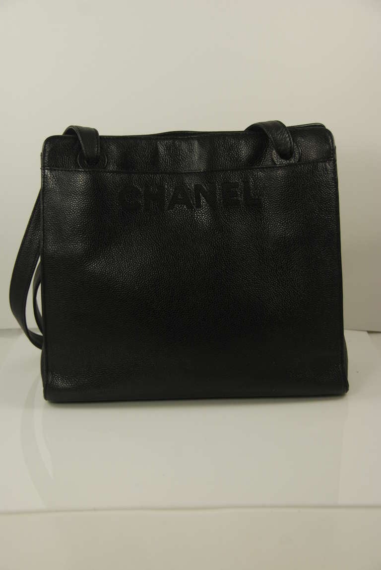 Vintage black cavier leather shoulder bag by Chanel. I believe this bag is from the 1990s but it may be from the early 2000s. Long double straps have a 15