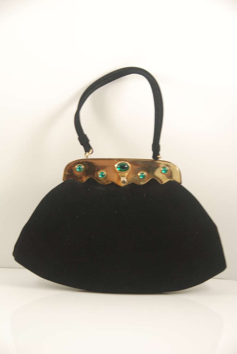 This mid-century bag is so much fun. The frame is gold metal set with faux cabochon emeralds. The frame is the same in the front and back. The bag opens by raising a lever attached to one of the stones. Clasp works well and bag closes with a loud