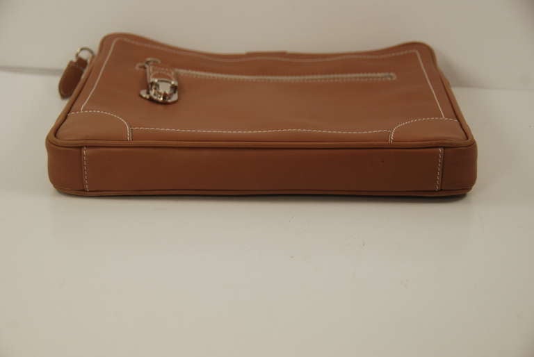 Luxurious tan leather tablet case by Marc Jacobs. The tablet fits in the canvas slip holder that snaps out of the bag. if you wish. Inside the case there  also room for other items as well as an additional slip compartment. On the front there is a
