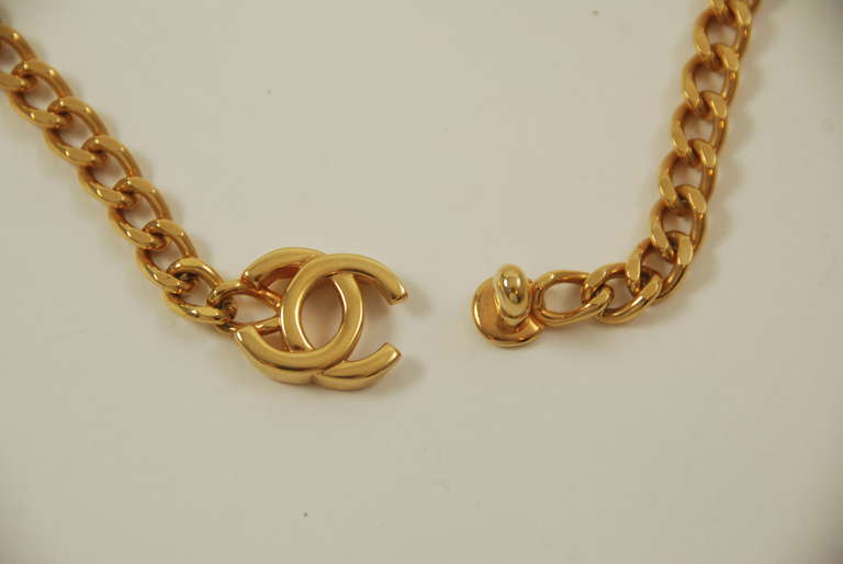 Gold tone short necklace with curb link chain and the interlocking C turn lock clasp. This is from the Autumn 1996 collection. The double C clasp is 0.75 inches wide.