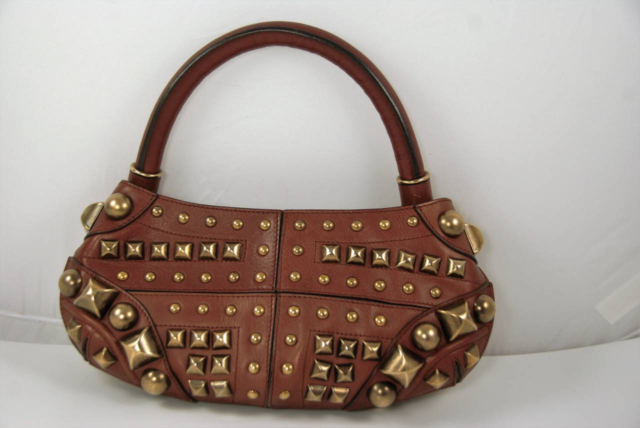 Burberry Prorsum brown leather handbag with antiqued brass studs. The handle has a 7