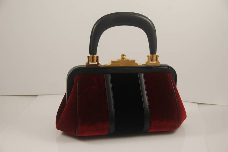 1970s Roberta di Camerino hand bag, brand new, never used. Pristine. Handle and trim are black leather, body of the bag is red and black velvet. Handle drop to the top of the bag is 3.5