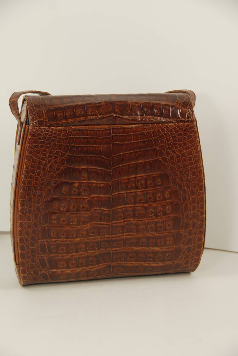 Brown alligator shoulder bag retailed by Henri Bendel, NYC. The strap is long enough so the bag can be worn cross body if you are on the smaller side. The strap has a 21.5
