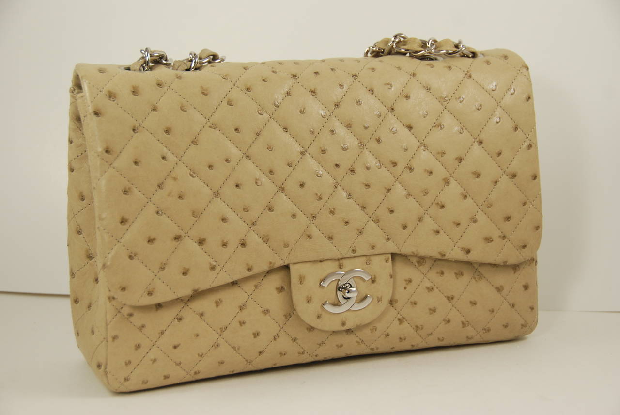 Chanel jumbo flap bag in a khakli/beige color. The bag is in fantastic condition and the skins are soft and supple. Comes with the authenticity card and Chanel dust bag. Metal on the bag is silver tone. When doubled the chain has a 13