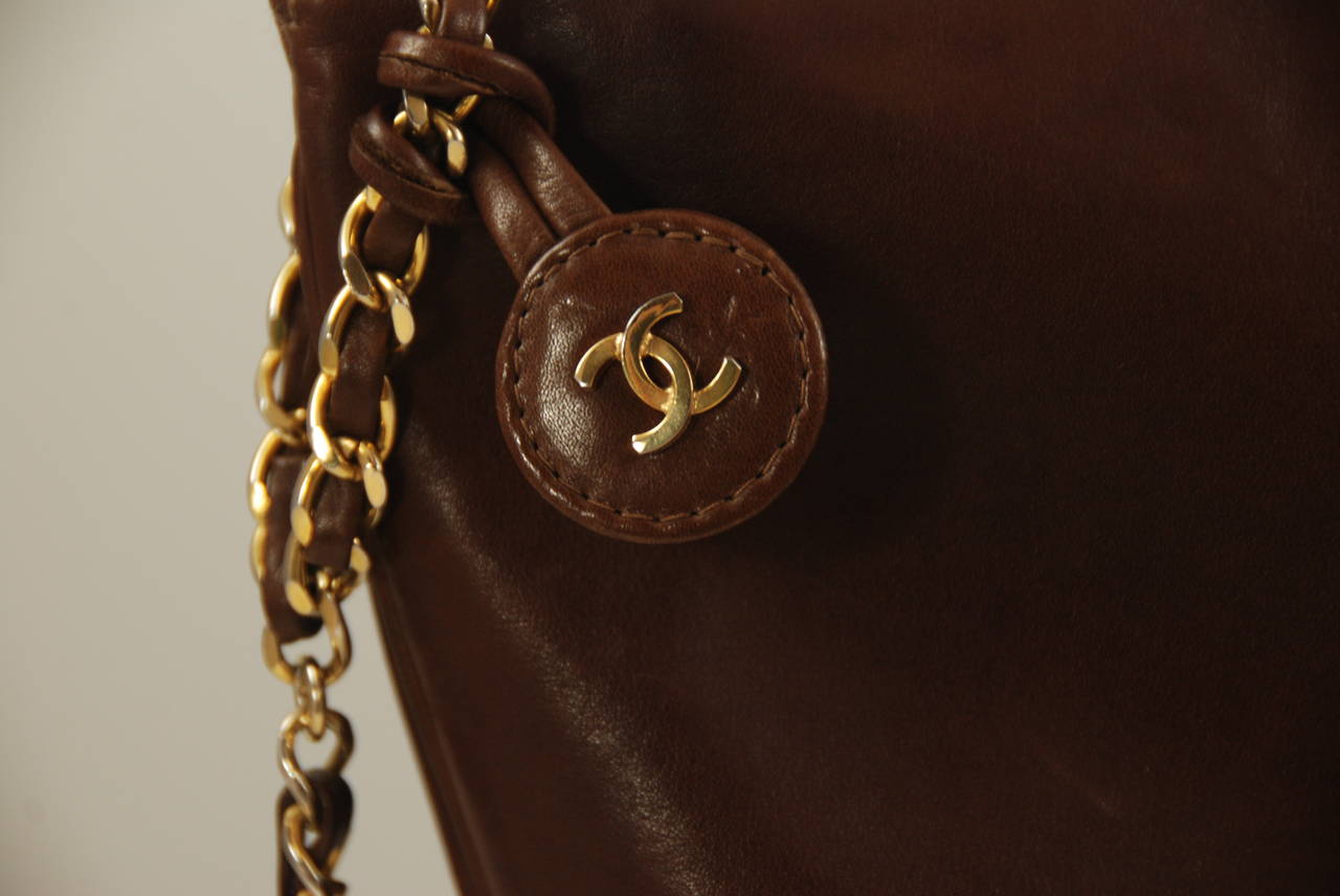 Vintage brown leather Chanel tote from the 1970s. This bag is pre-authenticity cards and icons but it does have the Chanel quality. Made of brown lambskin with the quilted pattern on the bottom and smooth leather on the  main part of the bag. Chain