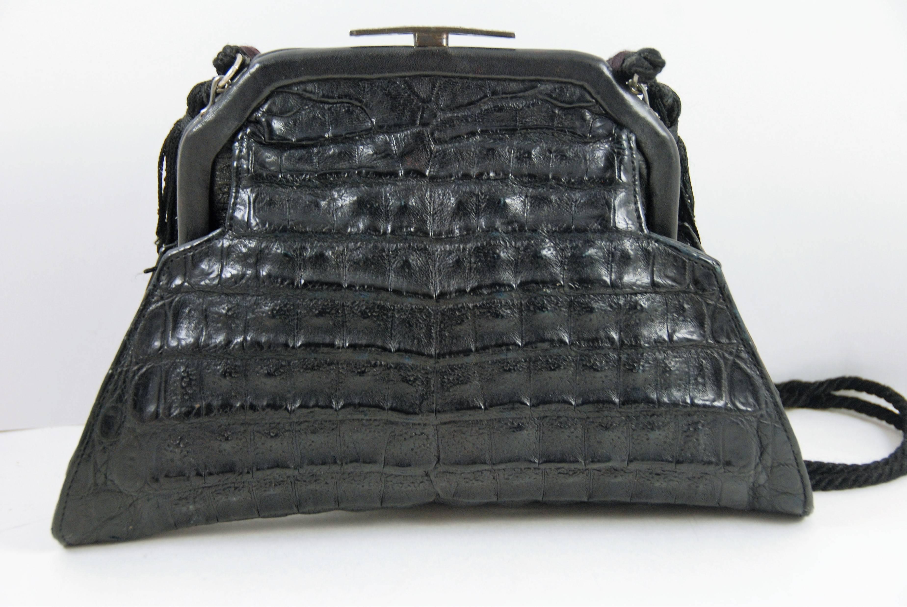 Jocomo evening bag from the 1980s made of black alligator and an art deco silver and marcasite frame. Jacomo worked in the 1980s and was know for adding new bodies to antique frames. Each bag was one of a kind. Inside has a satin lining in brown and