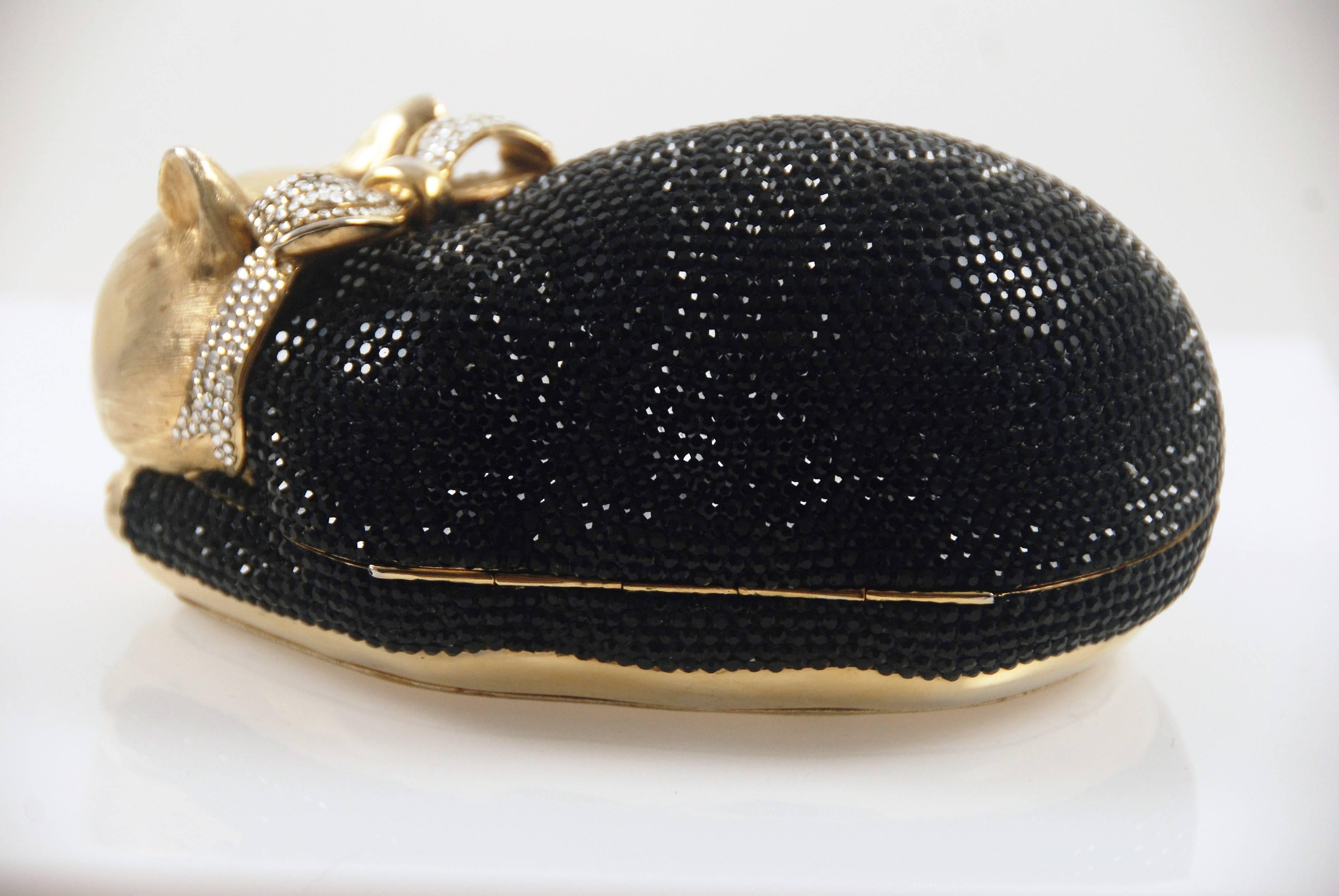 Charming sleeping kitty minaudiere by Judith Leiber. Done in black rhinestones with a clear rhinestone bow. Bag closes with loud click and closes securely. One of Leiber's most popular and enduring designs.