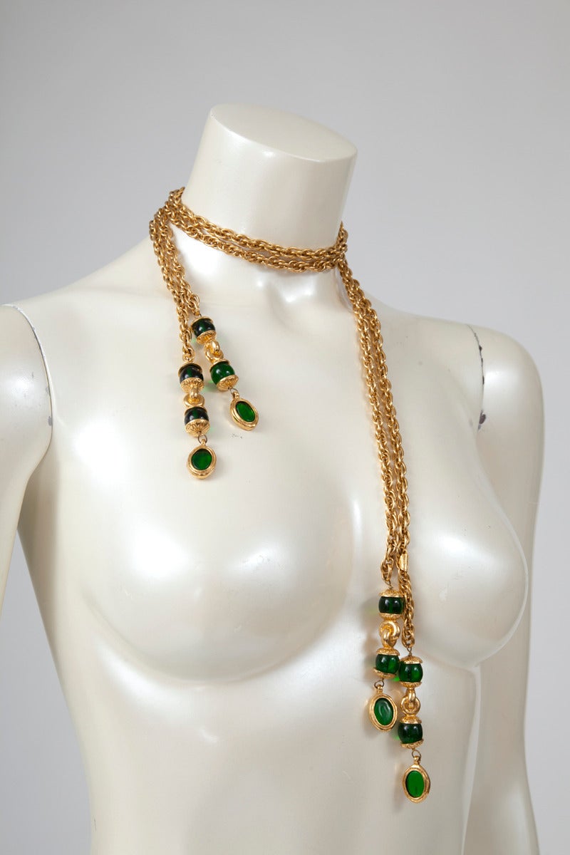 Rare late 70's - early 80's Chanel green Gripoix glass intricately double chain. It could be worn either as a belt or as a necklace with different lengths. Shiny 18k gold plated finish. Each end of the lariat features four green Gripoix spherical