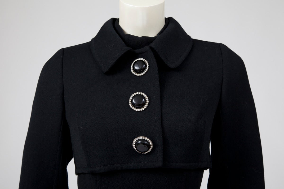 This fantastic 60’s Miguel Rueda soft wool black dress suit will be the perfect addition to a modern wardrobe. Together with a bolero jacket, the dress has a flattering cut, skimming the body until the waist level and then, an A-line cut until the