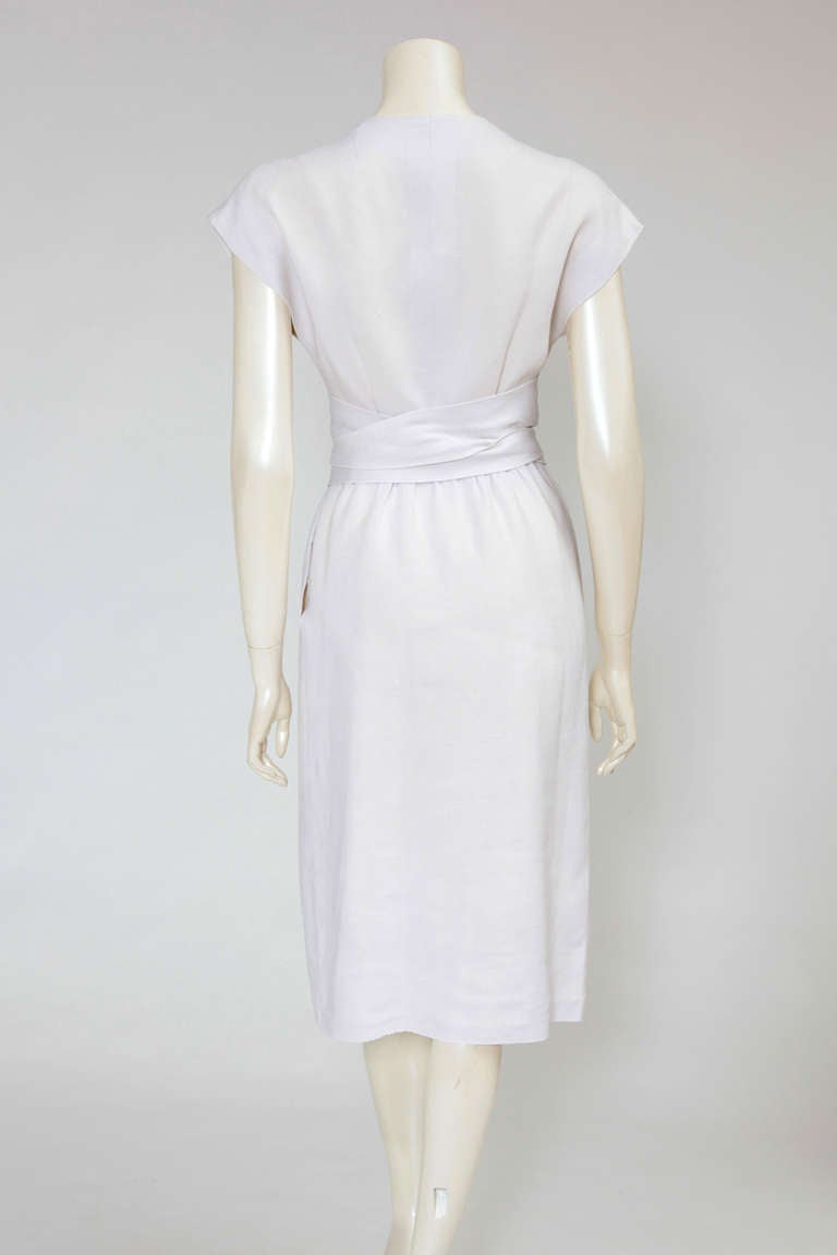 Spring-Summer 1960 Givenchy (un-labelled) haute couture “Jeanne Moreau” off-white linen day dress with pointed cummerbund belt fastened with a single button, tying obi-style at the front. Note that the hem is not stitched enabling the buyer to
