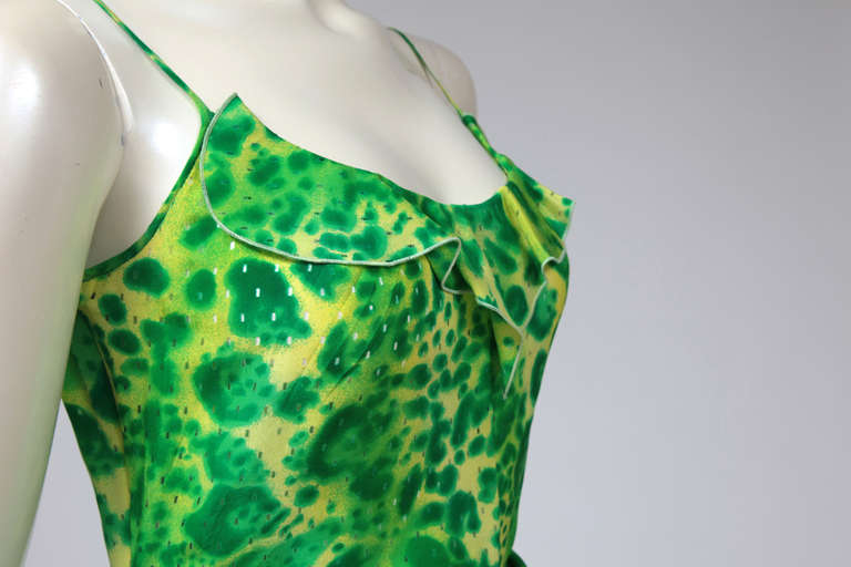 Early 90’s summer cocktail draped asymmetrical dress with ruffle on the neckline. Punchy shades of acid yellow and apple green leopard print. The dress closes with a zip and a hook on the left side, internal belt. Like a “second skin” see-trough