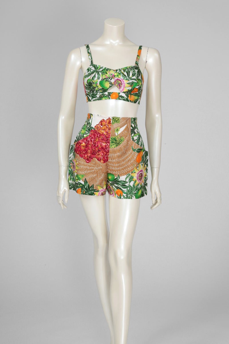 Gorgeous late 80's - early 90's Hermes printed silk twill bra top and high waisted mini shorts with two side pockets. Colorful print of tropical flowers, fruits and palms. Labeled a size FR 36, the set runs small to size. Fully lined in white silk,