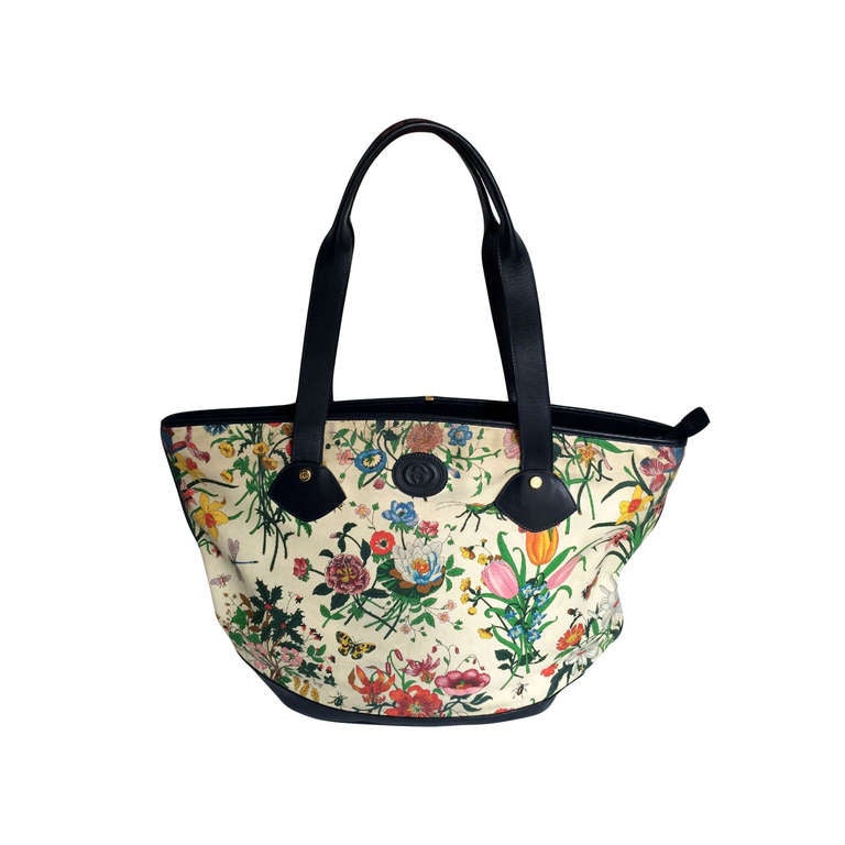 Early 80's lovely large navy blue leather and canvas Flora print vintage tote bag. This item has been cleaned and the leather repolished. The inside is entirely lined in cream leather. The bag can be totally zipped up, with a large internal fully