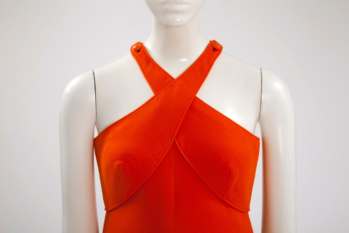 This late 60’s orange Courreges maxi dress is a great example of the modernist design for which André Courrèges is famous. Of structured A-line silhouette and with unusual neckline, a seam running around the bust creates an advantageous effect.