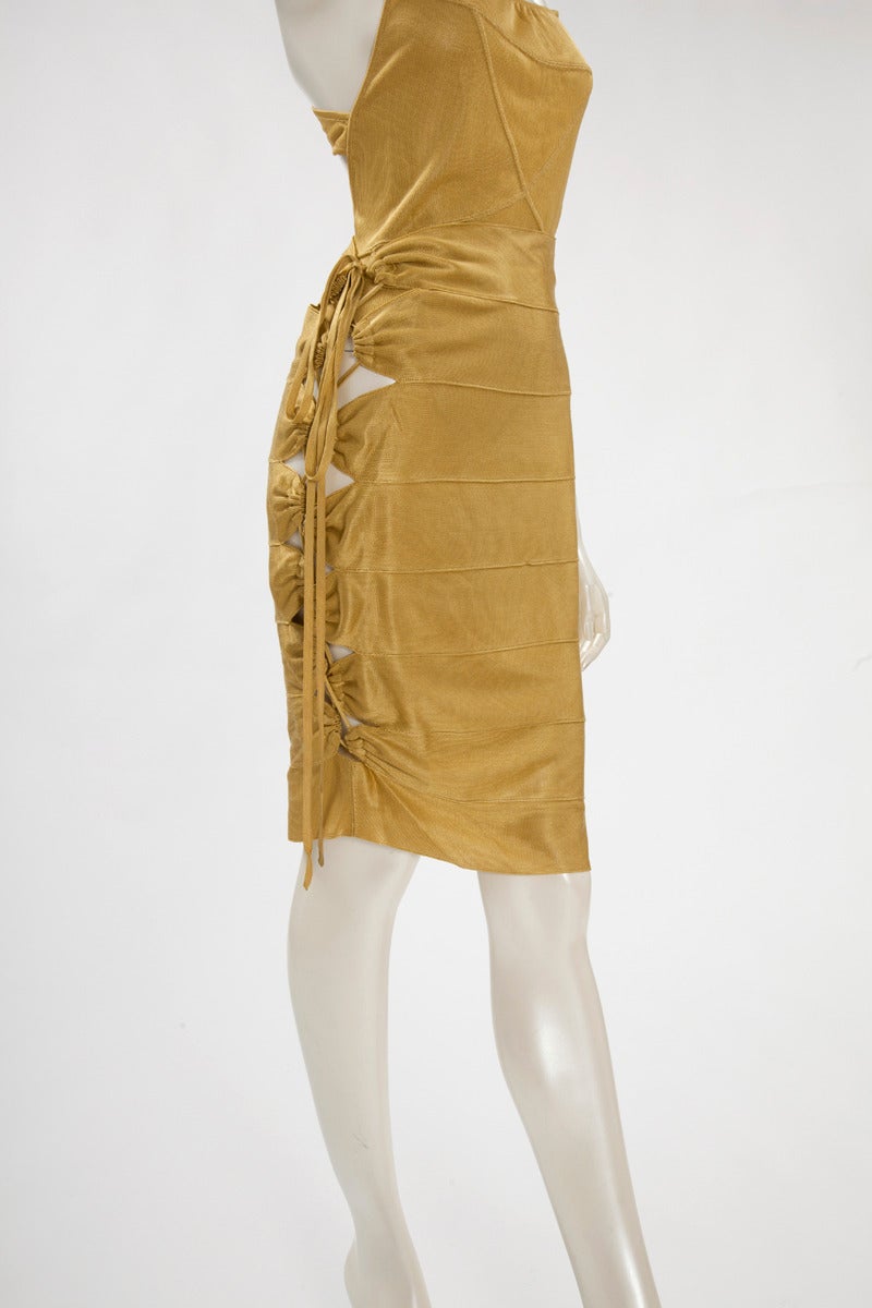 Consisting of a bodysuit and a cut-out skirt, this iconic Alaia design featuring adjustable bandage is nowadays displayed in museums and/or targeted exhibitions. Made in Italy. Please note that the ensemble is size L and that the mannequin is a size