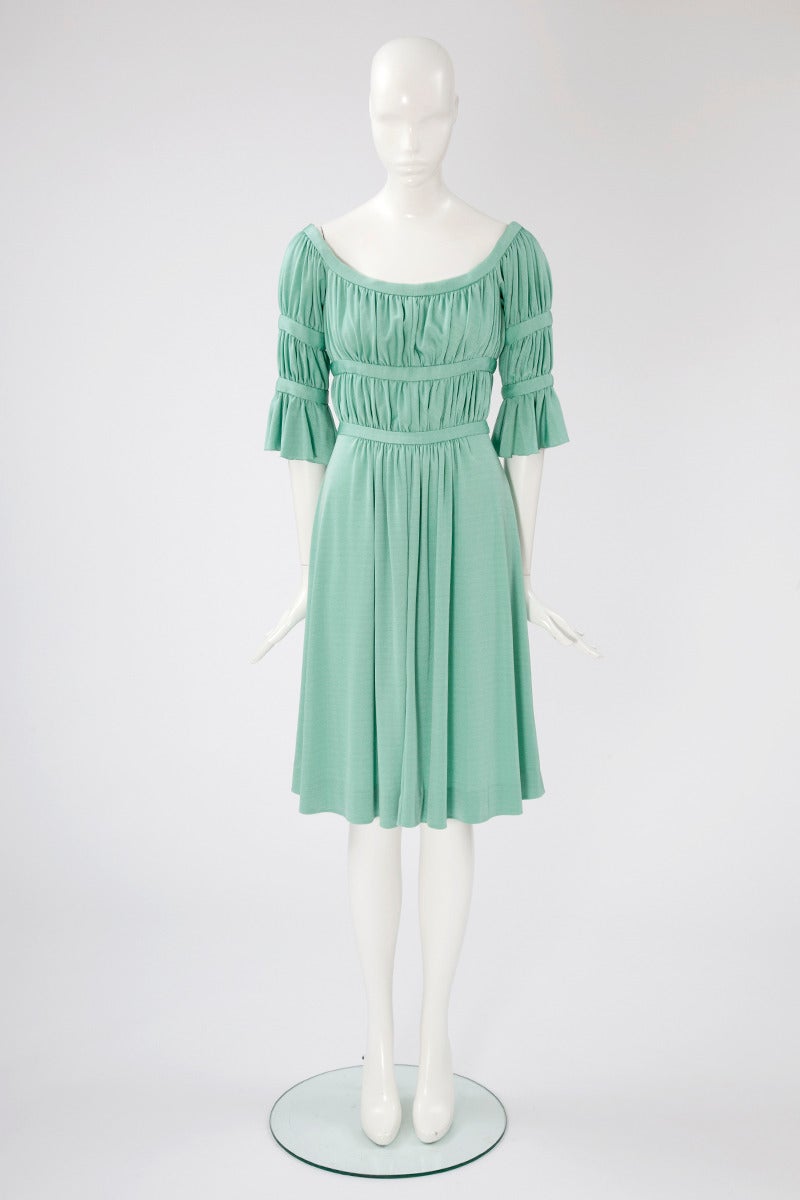 Late 60's - early 70's adorable antique style Loris Azzaro dress. Flattering round neckline and empire line silhouette. The green jade jersey is nicely gathered over the bust, waistline and at the arms, with the skirt falling in pleats. The dress