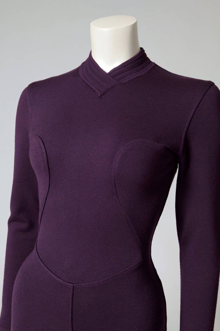 Recognizable and classic 90's Alaia plum mini dress, made of his signature stretch knit wool fabric. Long sleeves and high crew neckline. Seam details on the skirt, bust, waist and hips. Zip in the middle of the back. Unlined, the dress is a size
