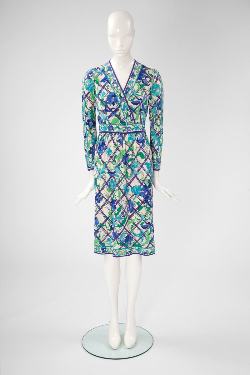 A wonderful 70's wrap style Pucci dress with an unusual floral print. Fitted bodice, v-neckline. Zip closure on the left side. Internal belt. This unlined 