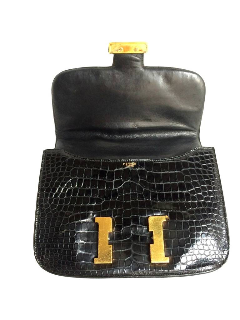 An early 70's classical black Hermes Constance bag in precious and rare crocodile Porosus skin with gold metal hardware. This piece has no blind stamp as it dates from before 1975. Its age has been certified by the Hermes store in Geneva who