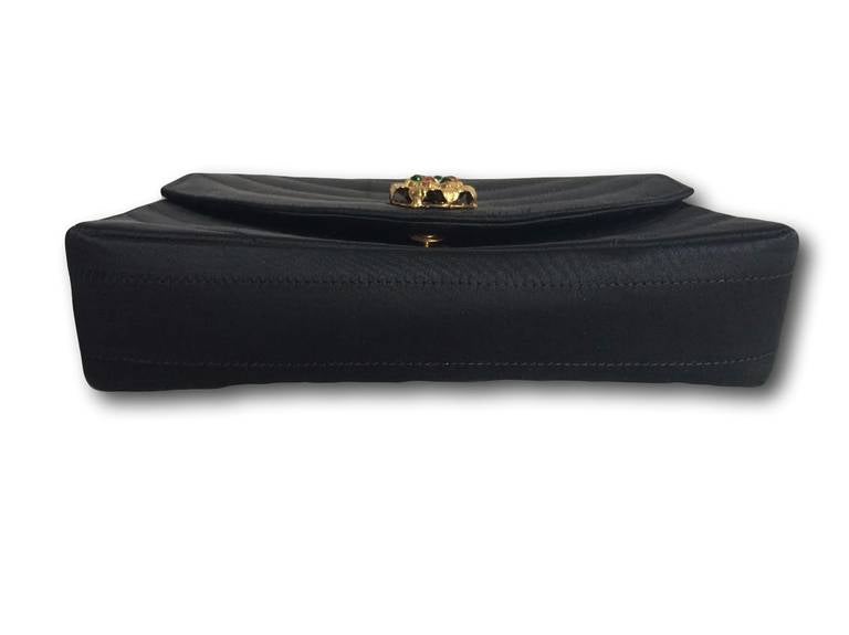 A rare and very chic stitched black satin 2.55 Chanel bag from 1986 with a jeweled 