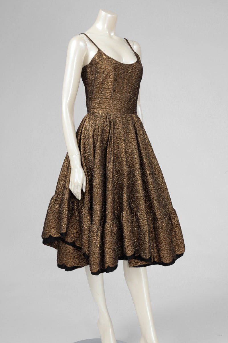 Stunning 70's labelled and numbered 12945 Lanvin party dress. Inspired by the fitted, waisted and flounced couture of the late 1950's, it is made of an exquisite bronze blistered silk and black satin. Being longer at the rear, it denotes a great
