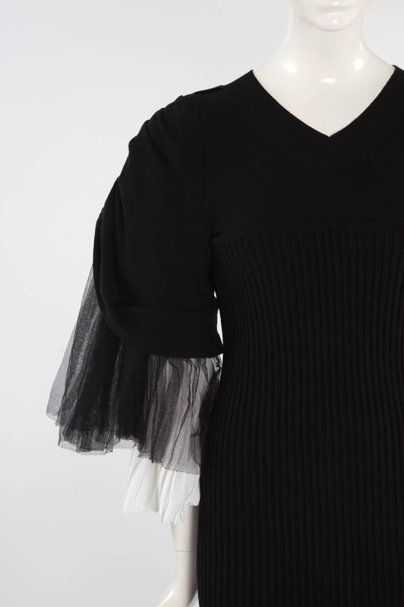 Runway Chanel black ribbed stretch mini dress (look 38 -> see picture 11) with white pleated knit and black tulle. Three-quarter length tiered ruffle raglan sleeves. The unlined dress features a V-neckline and closes with a zip at the back. Tagged a