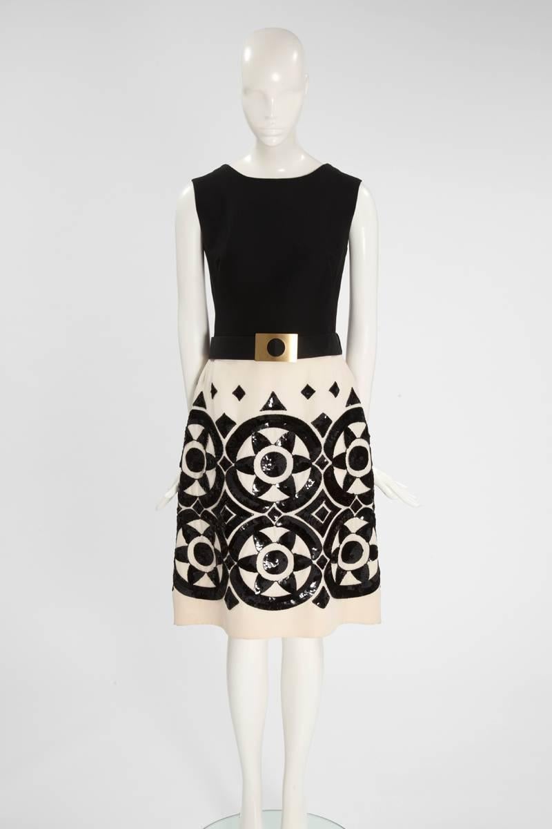 This 60s “attributed to” Valentino haute couture dress is crafted from black and cream soft wool and silk. Having the flattering 60s A-line silhouette with a charming boat neck, the skirt has been delicately hand-embroidered with black sequins and