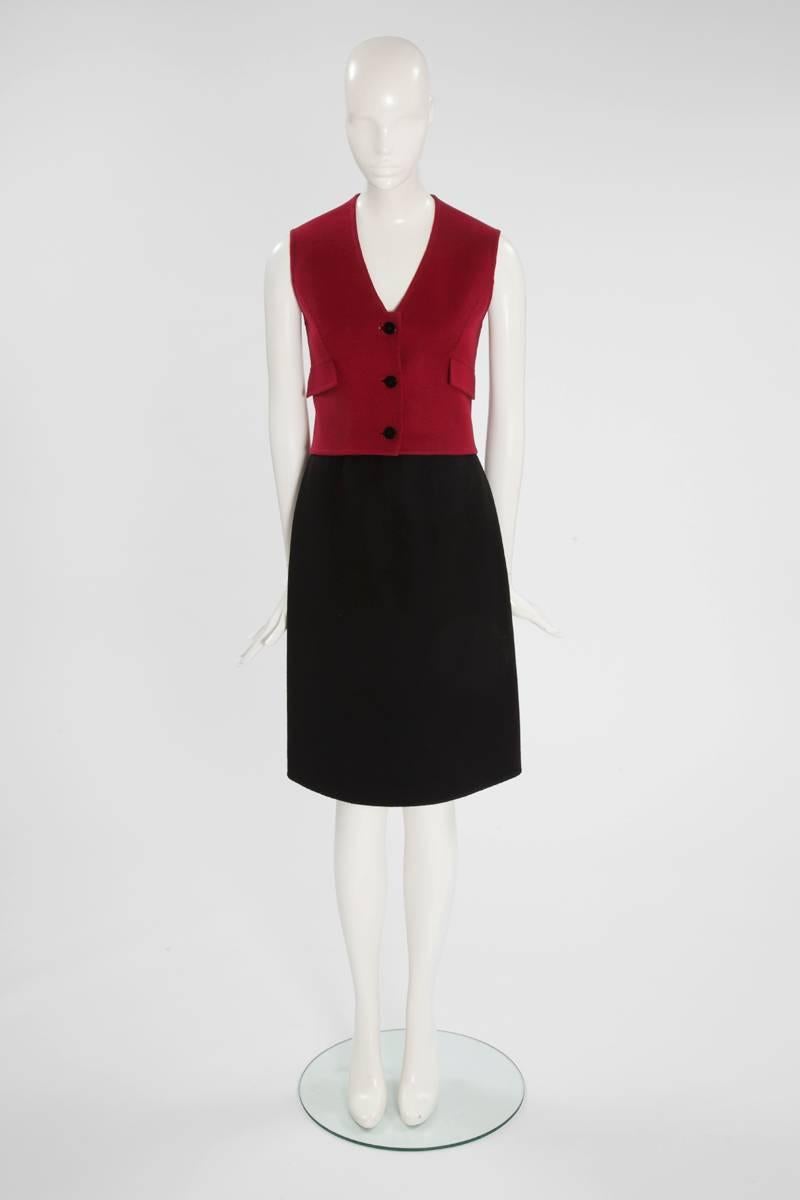 This Valentino haute couture skirt suit is a chic option for the office or simply to be elegant. Constructed in black and burgundy cashmere wool the skirt suit features a plunging neckline waistcoat and knee length skirt. The sleeveless unlined top