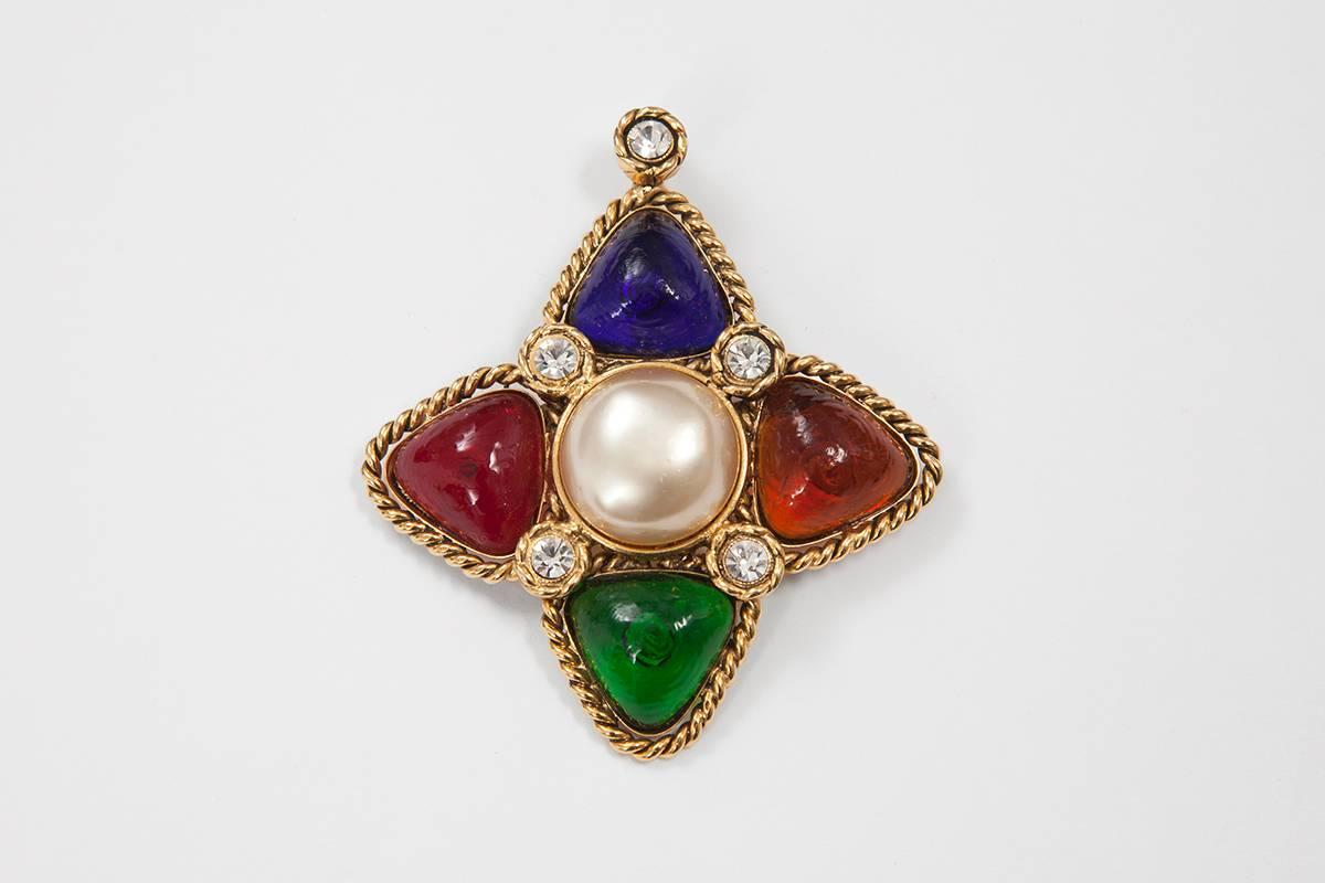 Chanel multicolored poured glass pendant or brooch in tones of sapphire, topaze, emerald and ruby highlighted with gilt metal, rhinestones and a central faux pearl. This 80s piece is signed "Chanel 23 Made in France", season 23, a time